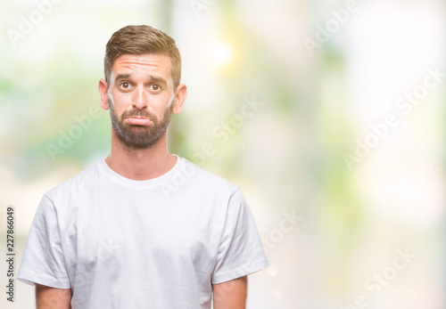 Young handsome man over isolated background depressed and worry for distress, crying angry and afraid. Sad expression.