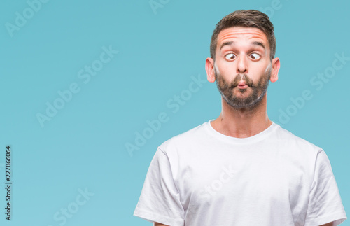 Photos Young handsome man over isolated background making fish face with lips, crazy and comical gesture