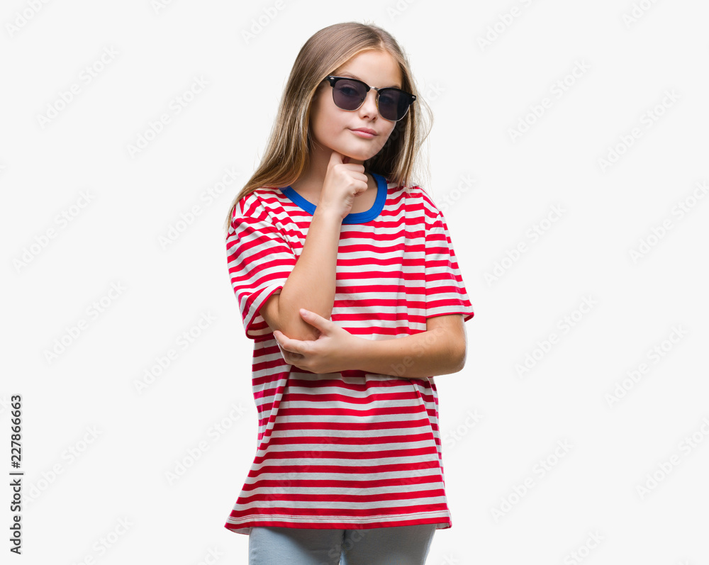 Young beautiful girl wearing sunglasses over isolated background with hand on chin thinking about question, pensive expression. Smiling with thoughtful face. Doubt concept. Young beautiful girl wearing sunglasses over isolated background with hand on chin thinking about question, pensive expression. Smiling with thoughtful face. Doubt concept.