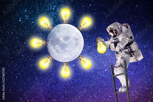 astronaut replaces a light bulb.elements of this image furnished by NASA