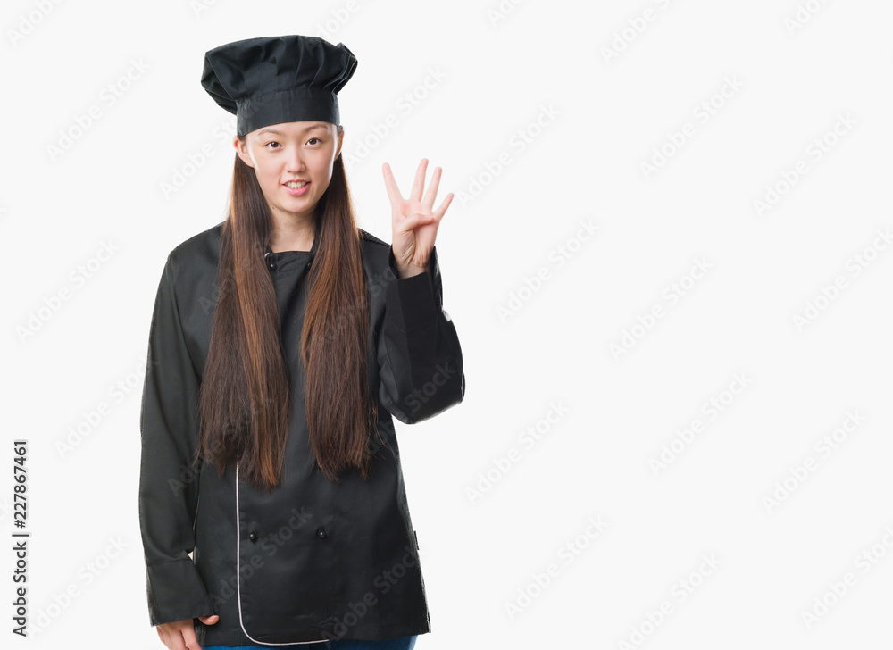 Young Chinese woman over isolated background wearing chef uniform showing and pointing up with fingers number four while smiling confident and happy. Young Chinese woman over isolated background wearing chef uniform showing and pointing up with fingers number four while smiling confident and happy.