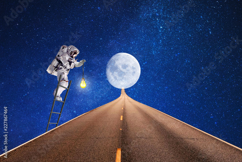 travel on  space moon.astronaut lighting route on moon.elements of this image furnished by NASA