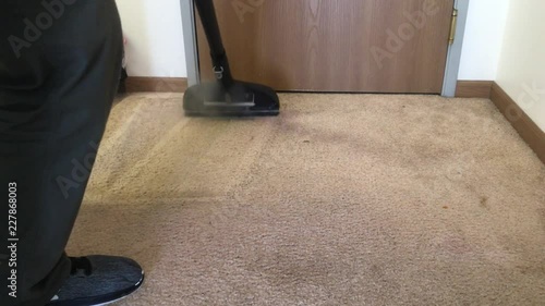 Carpet cleaner uses wand with hot water and steam to clean high traffic entryway area.  
