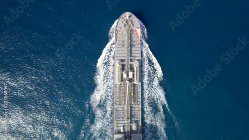 Large crude oil tanker roaring across The Mediterranean sea - Aerial footage following the ship