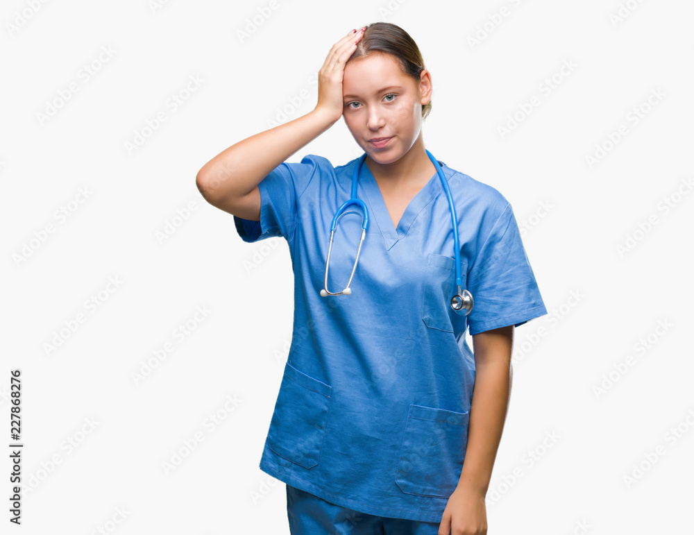 Young caucasian doctor woman wearing medical uniform over isolated background confuse and wonder about question. Uncertain with doubt, thinking with hand on head. Pensive concept.