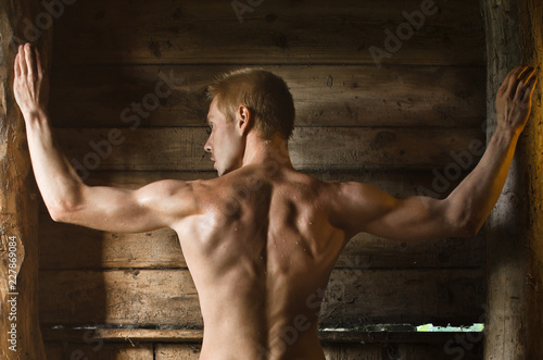 back of a handsome man in a rustic barn