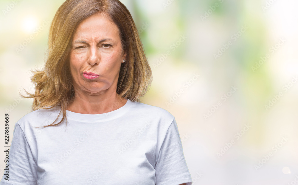 Middle age senior hispanic woman over isolated background skeptic and nervous, frowning upset because of problem. Negative person. Middle age senior hispanic woman over isolated background skeptic and nervous, frowning upset because of problem. Negative person.