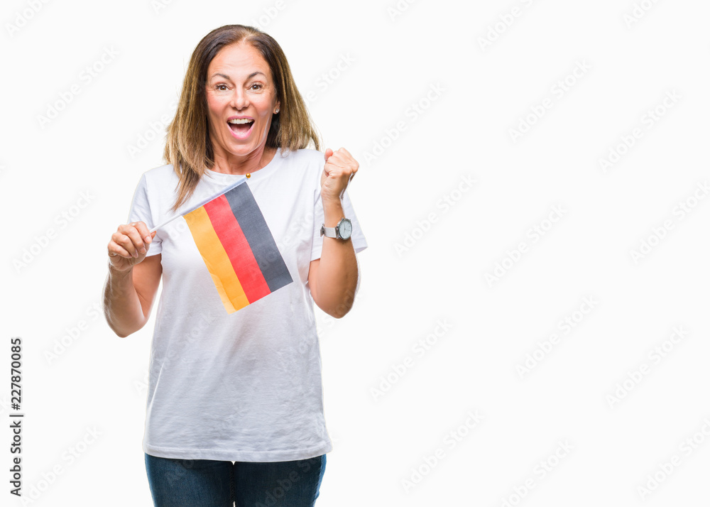 Middle age hispanic woman holding flag of Germany over isolated background screaming proud and celebrating victory and success very excited, cheering emotion Middle age hispanic woman holding flag of Germany over isolated background screaming proud and celebrating victory and success very excited, cheering emotion