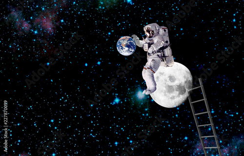 the spaceman sittig on moon.elements of this image furnished by NASA