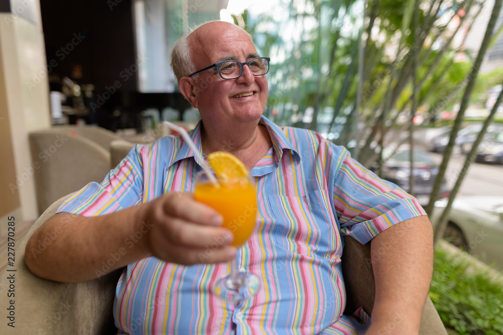 Overweight senior tourist man exploring around the city of Bangk Overweight senior tourist man exploring around the city of Bangk