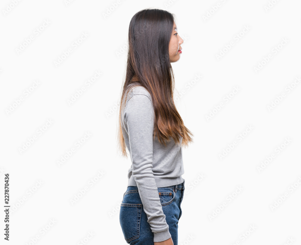 Young asian woman over isolated background looking to side, relax profile pose with natural face with confident smile. Young asian woman over isolated background looking to side, relax profile pose with natural face with confident smile.