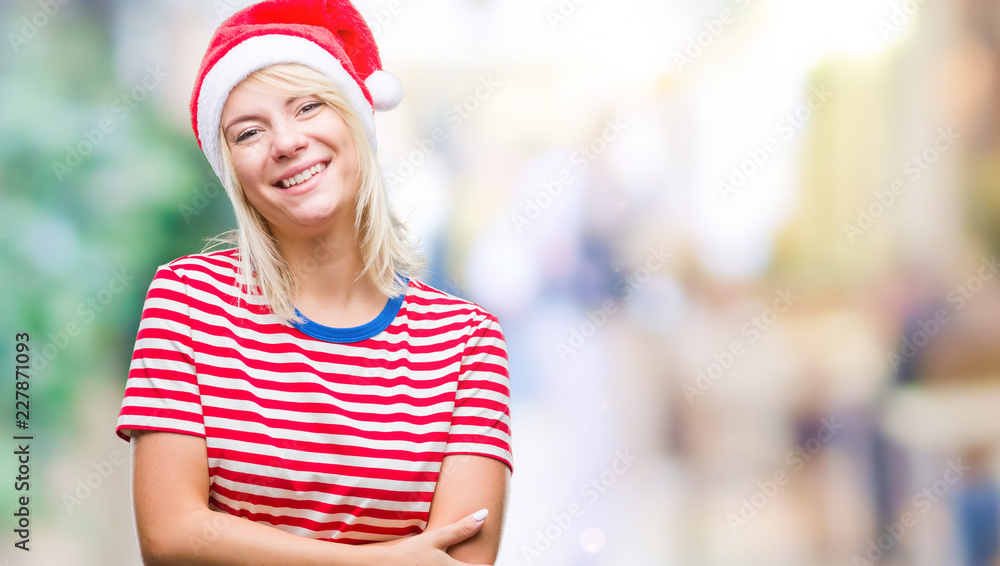 Young beautiful blonde woman wearing christmas hat over isolated background happy face smiling with crossed arms looking at the camera. Positive person.