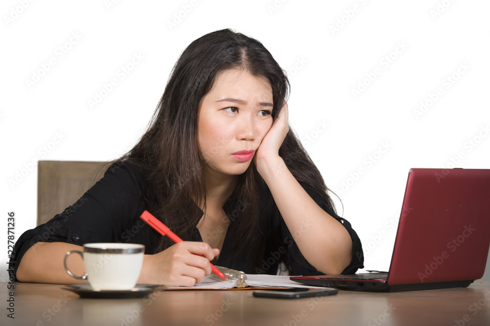 beautiful sad and depressed Asian Chinese business woman working in stress at office computer desk feeling overwhelmed and frustrated suffering headache and depression beautiful sad and depressed Asian Chinese business woman working in stress at office computer desk feeling overwhelmed and frustrated suffering headache and depression