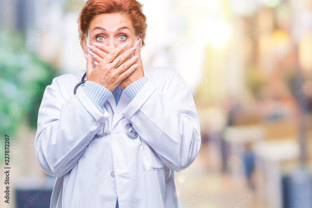 Senior caucasian doctor woman wearing medical uniform over isolated background shocked covering mouth with hands for mistake. Secret concept. Senior caucasian doctor woman wearing medical uniform over isolated background shocked covering mouth with hands for mistake. Secret concept.