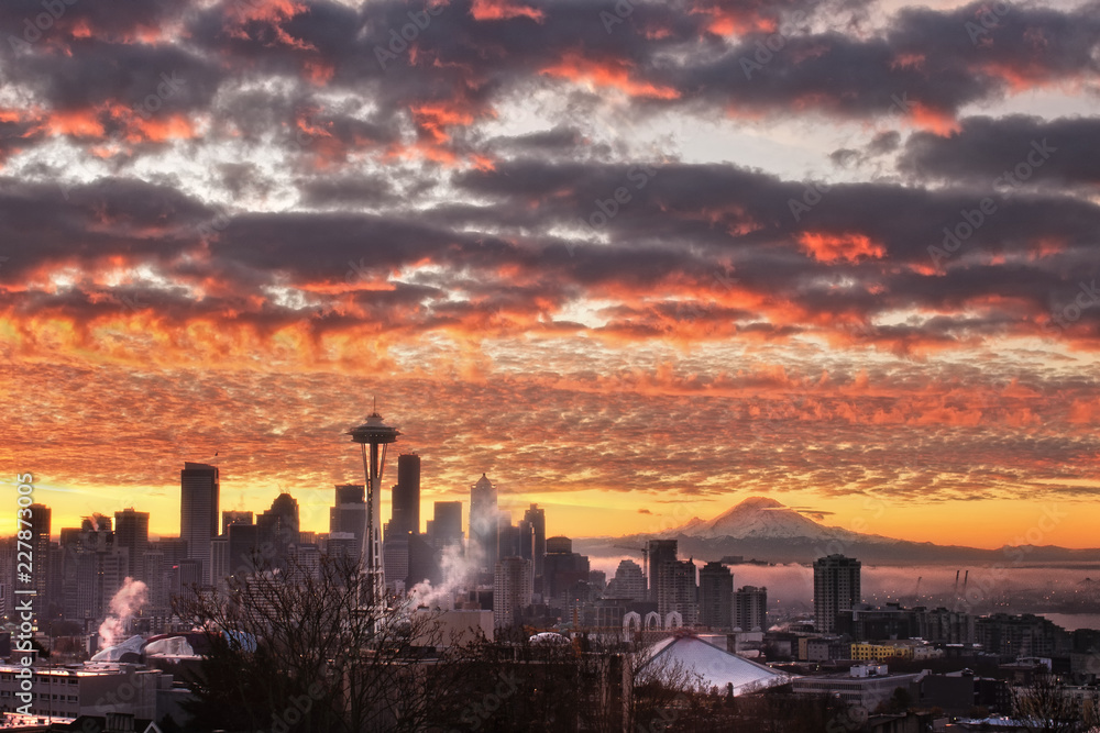 Foggy colorful sunrise over the Seattle skyline with Mount Rainier