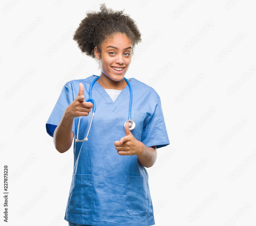 Young afro american doctor woman over isolated background pointing fingers to camera with happy and funny face. Good energy and vibes. Young afro american doctor woman over isolated background pointing fingers to camera with happy and funny face. Good energy and vibes.