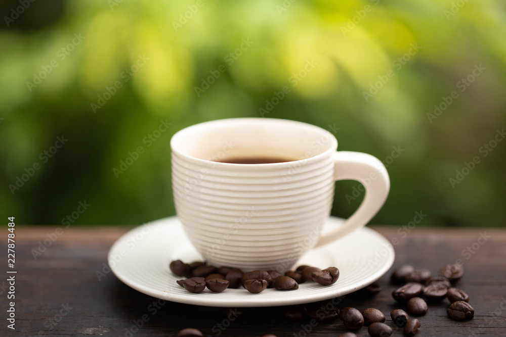 white cup of black coffee with green background white cup of black coffee with green background