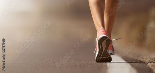 Running shoe closeup of woman running on road with sports shoes