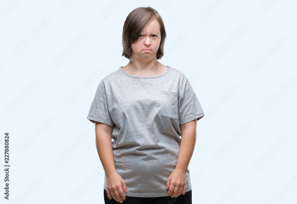 Young adult woman with down syndrome over isolated background skeptic and nervous, frowning upset because of problem. Negative person. Young adult woman with down syndrome over isolated background skeptic and nervous, frowning upset because of problem. Negative person.