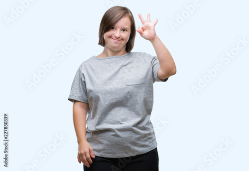 Wallpaper Mural Young adult woman with down syndrome over isolated background smiling positive doing ok sign with hand and fingers. Successful expression. Torontodigital.ca
