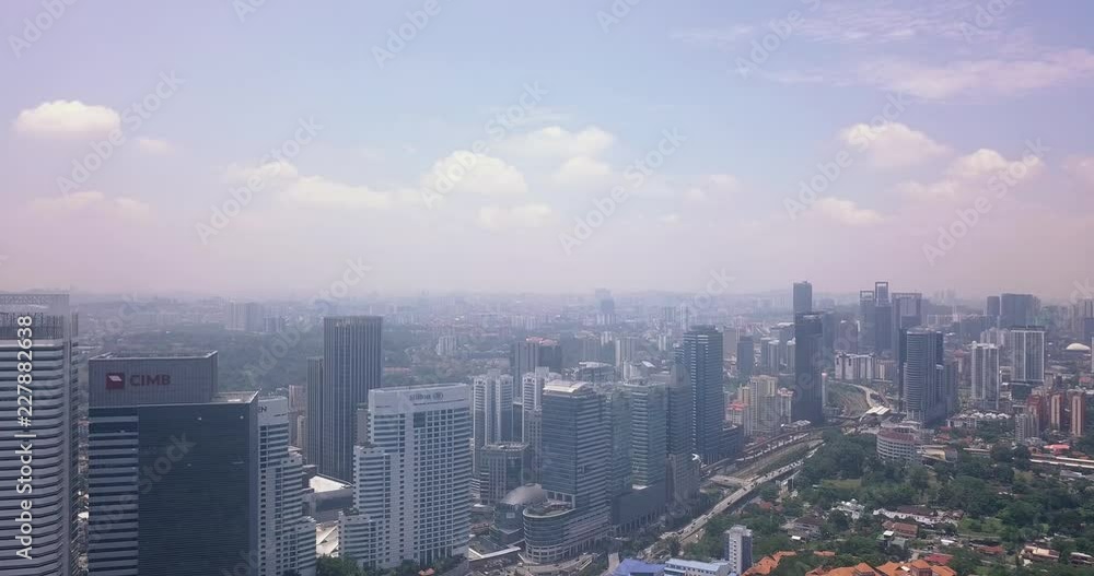 Aerial view of Malaysia, Kuala Lumpur buildings and skyscraper during the day with some clouds Aerial view of Malaysia, Kuala Lumpur buildings and skyscraper during the day with some clouds