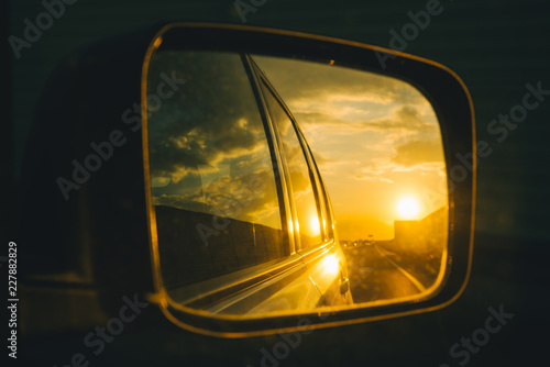 car on highway. sunset in car mirror reflection © phpetrunina14