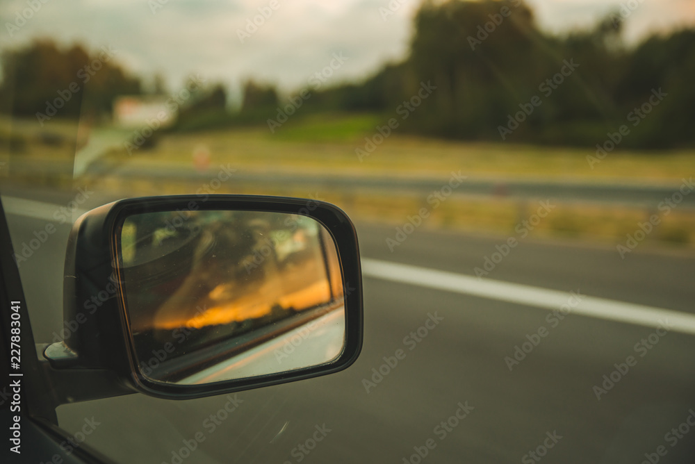 car on highway. sunset in car mirror reflection car on highway. sunset in car mirror reflection