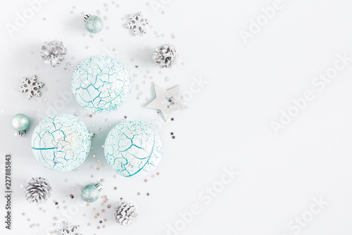 Christmas composition. Christmas blue and silver decorations on white background. Flat lay, top view, copy space