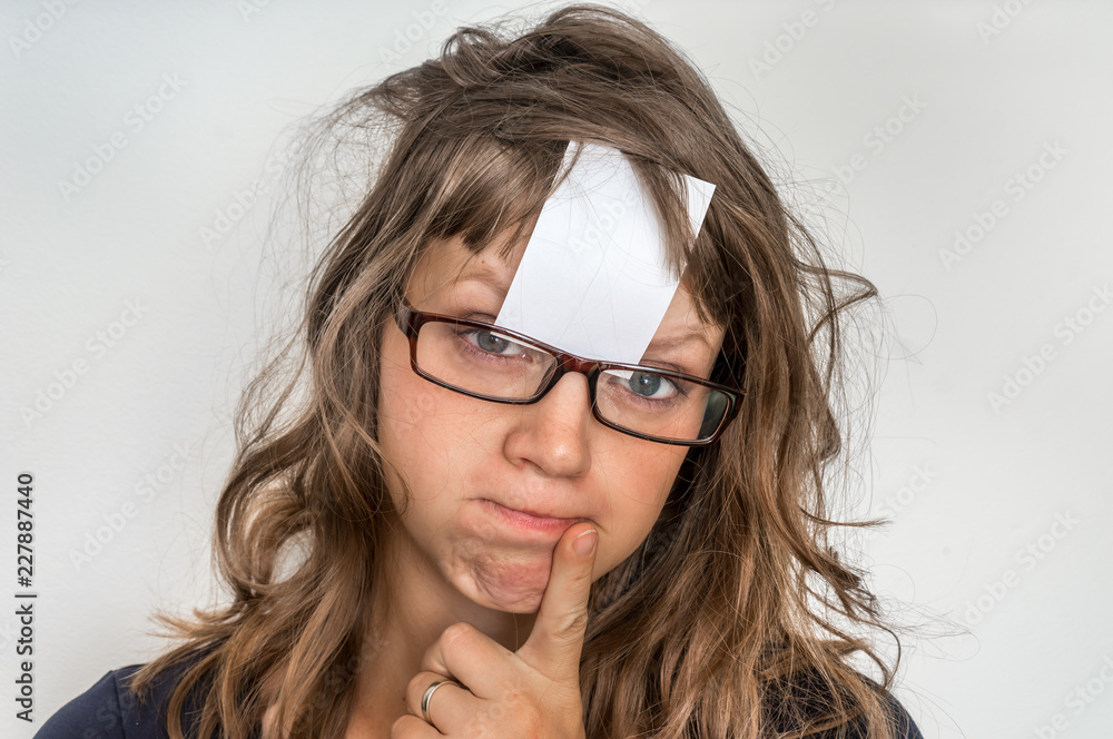 Funny woman with blank white sticky paper over her forehead Funny woman with blank white sticky paper over her forehead
