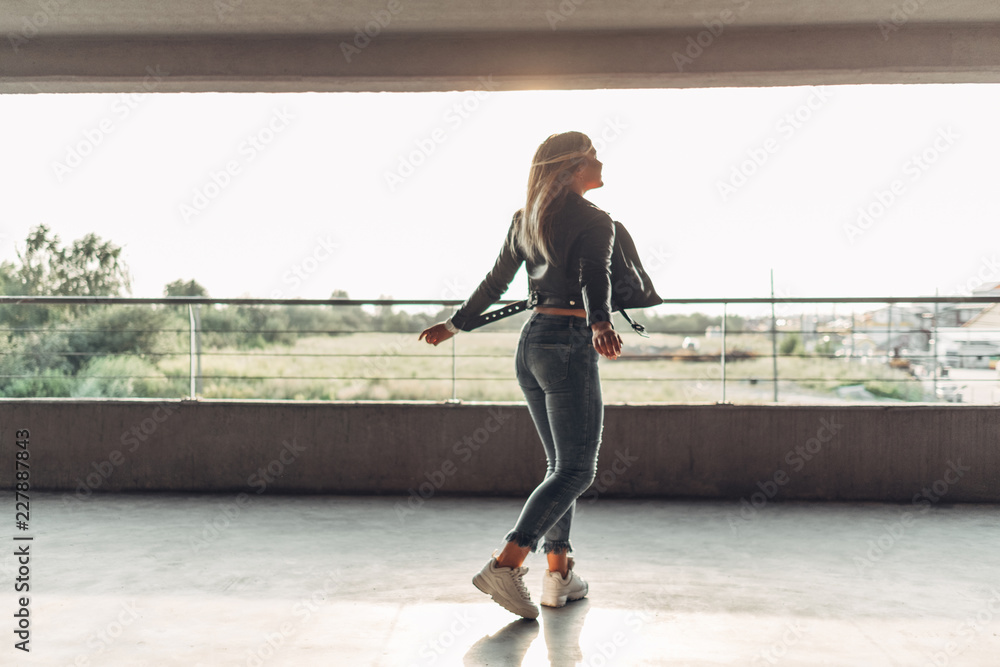 Beauty Girl in a Black Leather Jacket at the Parking Garage Beauty Girl in a Black Leather Jacket at the Parking Garage