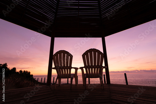 Fototapeta Naklejka Na Ścianę i Meble -  Beach bed with sun backlighting twilight time