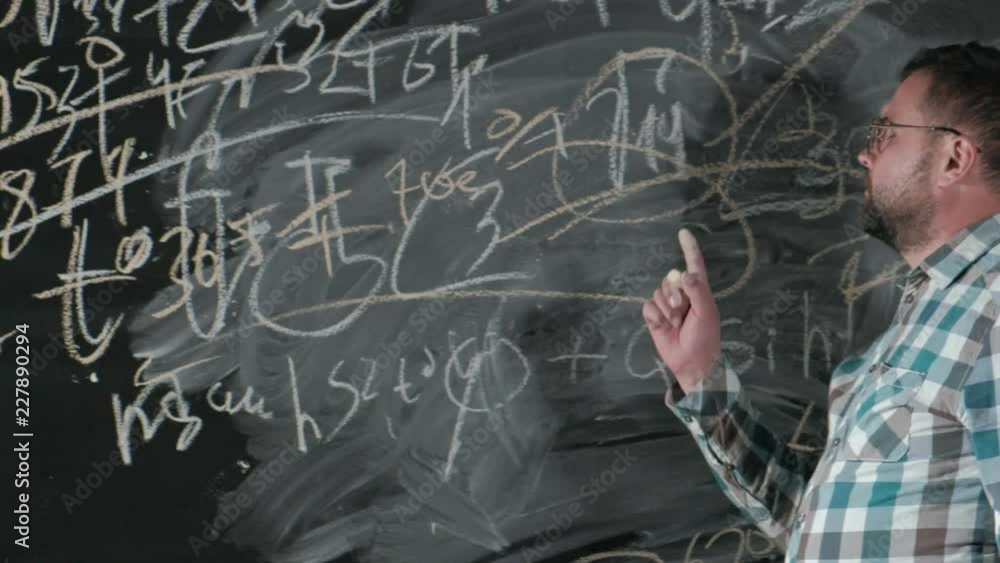 A brilliant mature mathematician brings a big board and completes an essay Complicated mathematical formula equation A brilliant mature mathematician brings a big board and completes an essay Complicated mathematical formula equation
