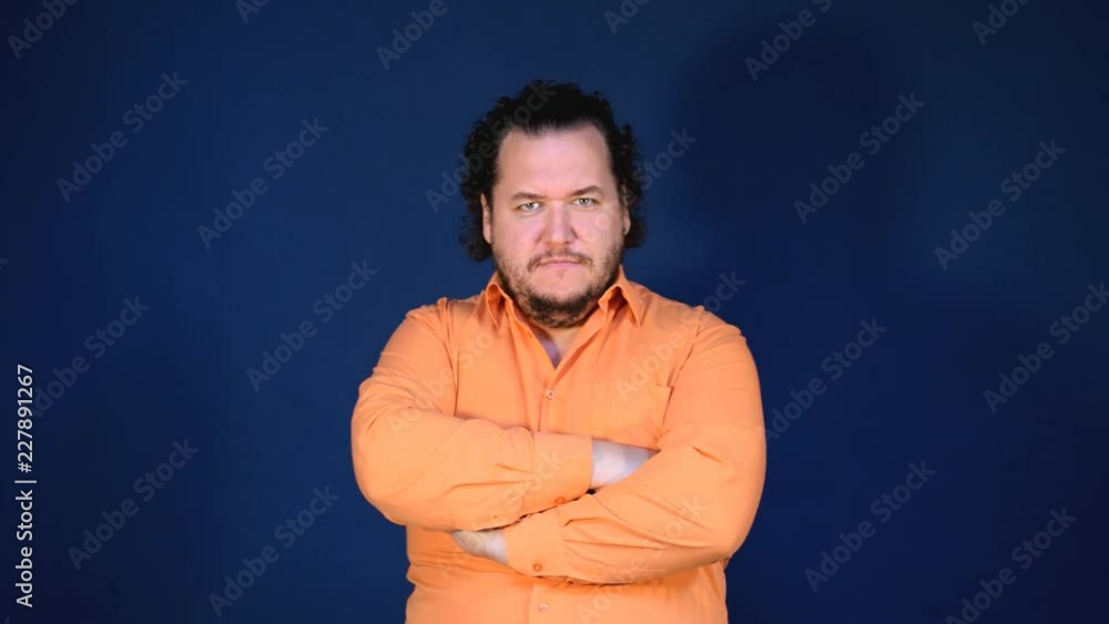 Funny fat man in orange shirt is waiting for the result and remains pleased with him. Business and finance Funny fat man in orange shirt is waiting for the result and remains pleased with him. Business and finance