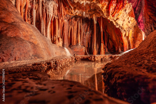 Stalactites and water pond in a limestone cave in Australia photo