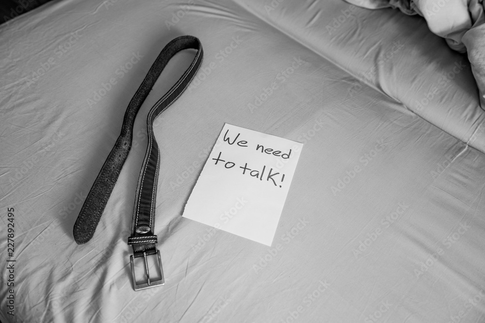 we need to talk! domestic corporal punishment.a note from infuriated  father. leather belt on the bed prepared for spanking. domestic discipline.  talking with strict parents about behaviour Stock Photo | Adobe Stock