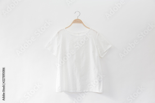 White colour blouse is clothes hanger on white background.close up.