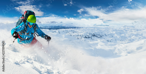 Alpine freeride skier with snow powder explosion