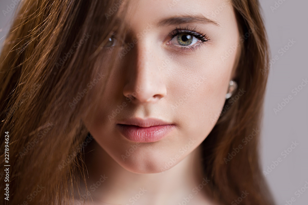 Horizontal closeup portrait of a beautiful young woman with clean skin, long eyelashes and natural beauty, fresh face Horizontal closeup portrait of a beautiful young woman with clean skin, long eyelashes and natural beauty, fresh face