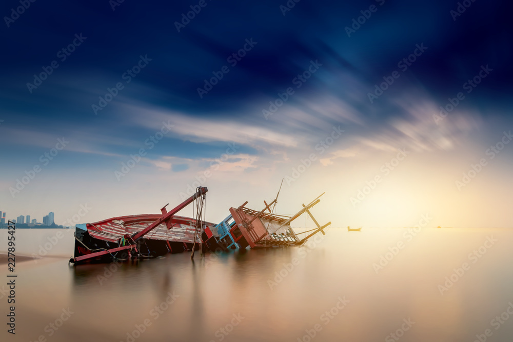 Old fishing wooden boat of the fisherman parked on the beach and the sunset sky is beautiful.. Old fishing wooden boat of the fisherman parked on the beach and the sunset sky is beautiful..