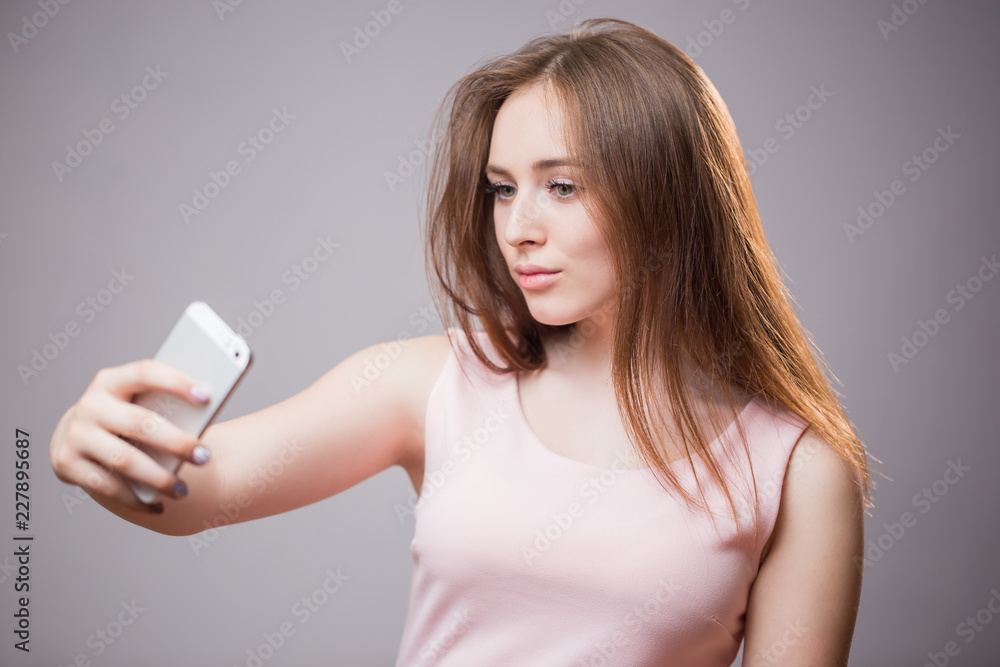 Closeup portrait of young cheerful readhead woman makes selfie on smartphone Closeup portrait of young cheerful readhead woman makes selfie on smartphone
