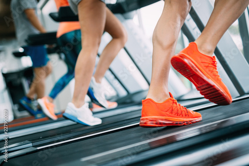 Group of friends exercising on treadmill machine