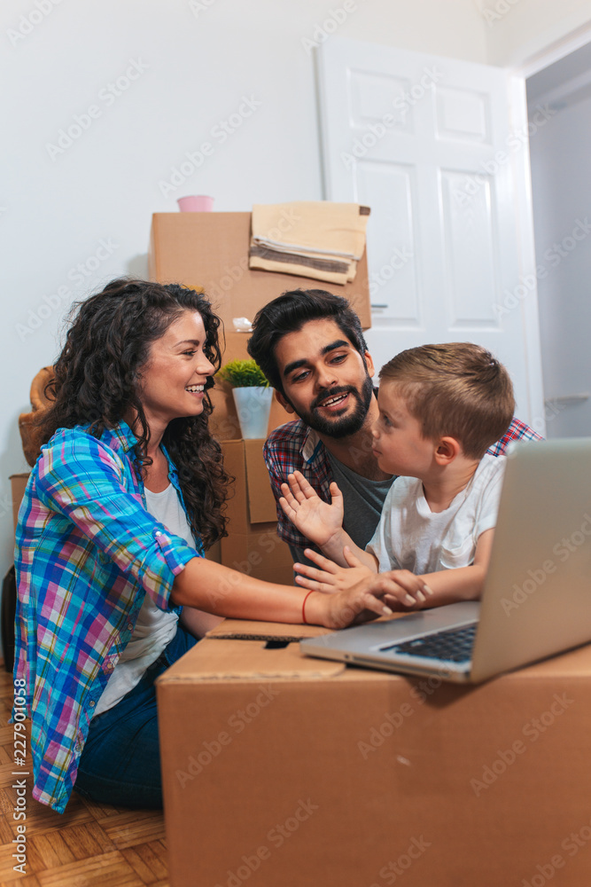 Happy young family having fun while moving into their new home. Happy young family having fun while moving into their new home.
