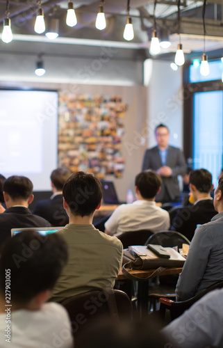 Confident Executive Businessman Speaks to Group of People During Successful Meeting Presentation. Presenter Manager and Team Have Discussion on Technology Consulting. Management Communication.