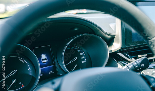 Detail of car dashboard, odometer and steering wheel