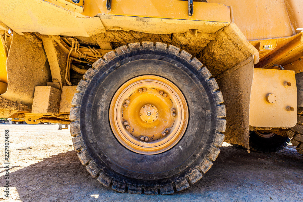 Large wheel of industrial heavy machinery - closeup Large wheel of industrial heavy machinery - closeup