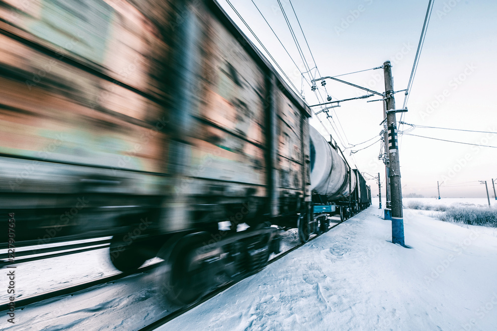 Fototapeta premium Winter railway and train with cargo.