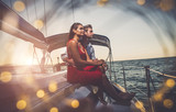 happy couple taking a romantic cruise on the sail boat