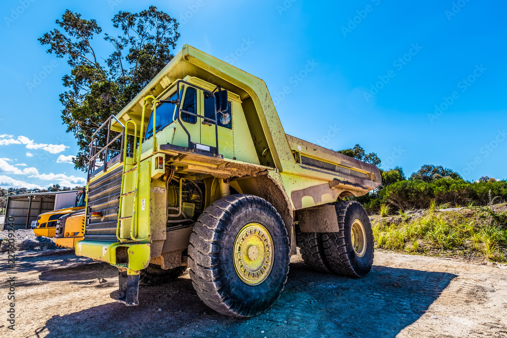 Large green dumper truck on construction site Large green dumper truck on construction site