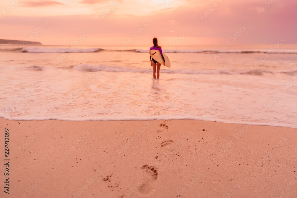 Surf girl with surfboard go to surfing. Surfer woman on a beach at sunset or sunrise. Surf girl with surfboard go to surfing. Surfer woman on a beach at sunset or sunrise.
