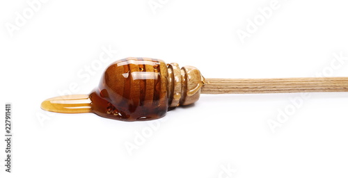 Honey and wooden dipper isolated on white background